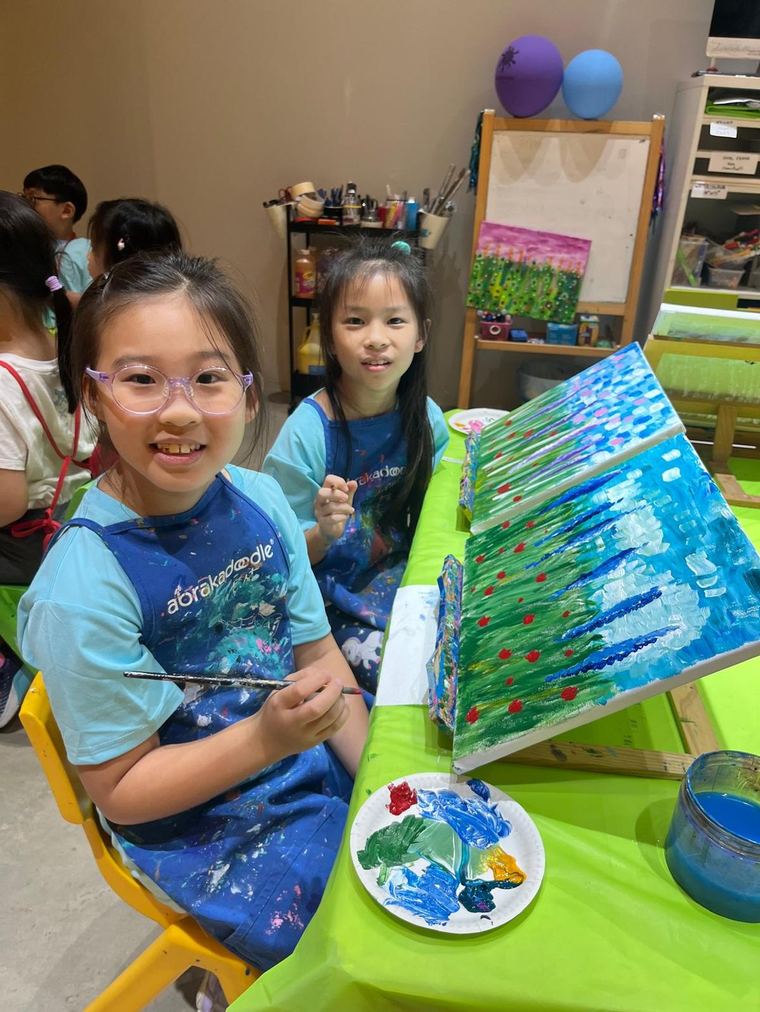 Children painting on canvas during the Imagine Mission